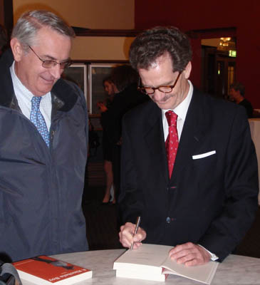 The author, Christopher Bevan (right), signing a copy of his novel for his head of Chambers, Geoff Lindsay SC (left)